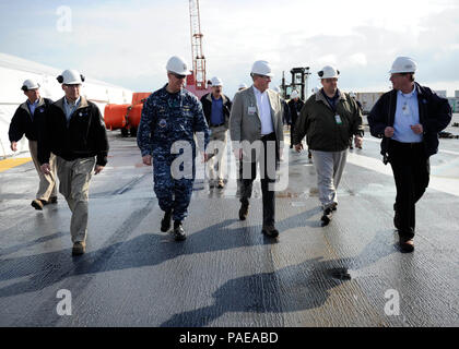 NEWPORT NEWS, Va. (Mar. 25, 2016) --  Rep. Mike Conaway of Texas tours the flight deck of Pre-Commissioning Unit Gerald R. Ford (CVN 78) with Capt. John F. Meier, the commanding officer of the ship, and Huntington Ingalls Newport News Shipbuilding employees during a visit to the ship. Ford is currently under construction at Huntington Ingalls Newport News Shipbuilding. (U.S. Navy photo by Mass Communication Specialist Seaman Cathrine Mae O. Campbell/Released) (This image was altered for security purpose by blurring out security badges) Stock Photo