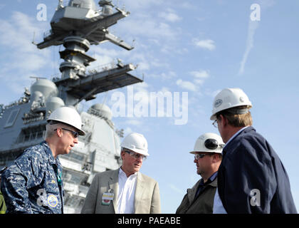 NEWPORT NEWS, Va. (Mar. 25, 2016) --  Rep. Mike Conaway of Texas tours the flight deck of Pre-Commissioning Unit Gerald R. Ford (CVN 78) during a visit to the ship. Ford is currently under construction at Huntington Ingalls Newport News Shipbuilding. (U.S. Navy photo by Mass Communication Specialist Seaman Cathrine Mae O. Campbell/Released) (This image was altered for security purpose by blurring out security badges) Stock Photo