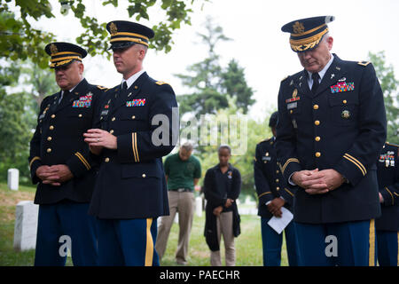 Chaplains bow their heads during at prayer at the 242nd U.S. Army Chaplain Corps Anniversary ceremony at Chaplain's Hill at Arlington National Cemetery, Arlington, Va., July 28, 2017.  A wreath was also laid at the Tomb of the Unknown Soldier by Chaplain (Maj. Gen.) Paul K. Hurley, chief of chaplains, U.S. Army Chaplain Corps, and Sgt. Maj. Ralph Martinez, regimental sergeant major, U.S. Army Chaplain Corps. Stock Photo