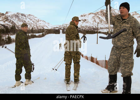 Lt. Col. Thomas Salberg, Commander, 24th Commandos (Great Britain) and Lt. Col. Francios Caron, Canadian Army Advanced Warfare Training Center prepare to ride the lift March 22, 2016 at the Northern Warfare Training Center at Black Rapids Training Site, Alaska. The two, joined by military partners from seven other countries including the U.S., attended NWTC’s 2nd annual Cold Regions Military Mountaineering Collaborative Training Event. The four-day event fostered collaboration between foreign partners by sharing military tactics and techniques in cold regions and mountainous terrain. Stock Photo