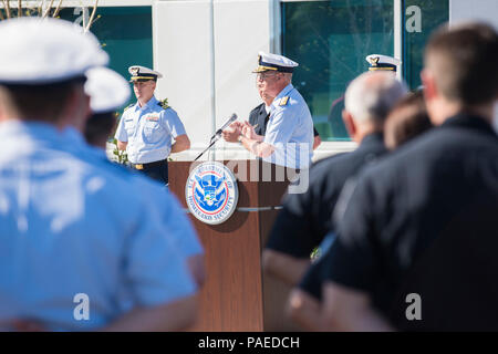 Coast Guard and Customs and Border Protection members watch as Rear Adm. Scott Buschman, commander, Seventh Coast Guard District, applauds the efforts of both agencies at their new joint operations center in Jacksonville, Florida, March 30, 2016. The new facility will lead to an even better working relationship between the agencies. U.S. Coast Guard photo by Petty Officer 1st Class Stephen Lehmann Stock Photo