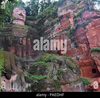 Leshan Giant Buddha 71 meters tall stone statue carved out of the cliff, faces confluence of Min River and Dadu River. Stock Photo