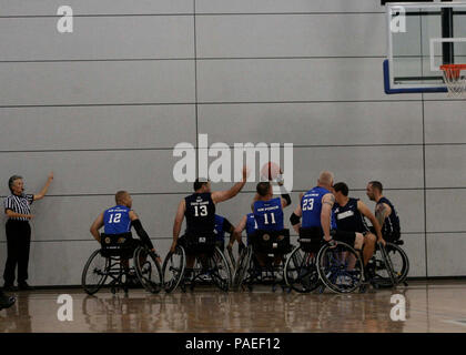 Team Navy/Coast Guard members strategically position themselves in a game of wheelchair basketball  against Team Air Force during the 2013 Warrior Games May 14. The Warrior Games includes competitions in archery, cycling, seated volleyball, shooting, swimming, track and field, and wheelchair basketball. The goal of the Warrior Games is not necessarily to identify the most skilled athletes, but rather to demonstrate the incredible potential of wounded warriors through competitive sports. More than 200 wounded, ill, or injured service members from the U.S. and U.K. armed forces are scheduled to  Stock Photo