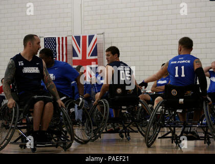 Team Navy/Coast Guard member retired Aviation Electrician's Mate Steven Davis of Turlock, Calif., and retired Operations Specialist 2nd Class Joseph Frank block opposing teammembers in a wheelchair basketball game against Team Air Force during the 2013 Warrior Games May 14. The Warrior Games includes competitions in archery, cycling, seated volleyball, shooting, swimming, track and field, and wheelchair basketball. The goal of the Warrior Games is not necessarily to identify the most skilled athletes, but rather to demonstrate the incredible potential of wounded warriors through competitive sp Stock Photo