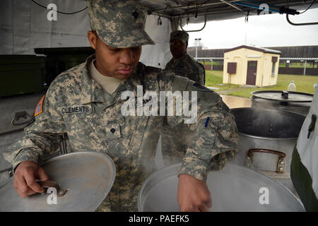 Cooks from the Wiesbaden Strong Teams Cafe Dining Facility (DFAC) brought a Mobile Kitchen Trailer (MKT) out to the Wackernheim Regional Range Facility on 30 March 2016 to feed the U.S. Army Europe Soldiers. The three cooks, (NCO Ssg. Raymond King, and Spc. Michelle Santiago-Lopez, and Spc. Kallan Clements) and one grill mechanic (Spc. Luke Wilson), set up the MKT, prepared the meals, fed the Soldiers, cleaned the MKT, and broke down the trailer to be used next time. After a long period of not being used, this is the first time the MKT has been set up to be used by the cooks for the Soldiers,  Stock Photo