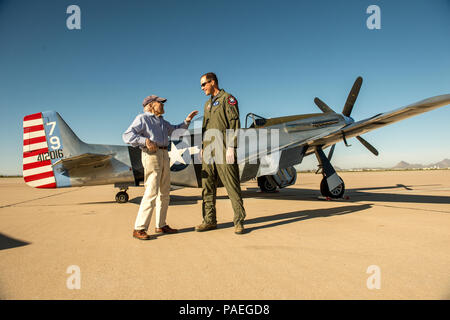 Col. James Meger, right, commander of the 355th Fighter Wing, listens to a war story told by Bill Lyons, 94, a former P-51D pilot with the 357th Fighter Squadron, 355th Fighter Group in England during WWII. The pilots talked on the flight line while it was open to the public before practice flights began at the Heritage Flight Training Course at Davis-Monthan AFB, Tucson, Ariz., Mar 5, 2016. (U.S. Air Force photo by J.M. Eddins Jr.) Stock Photo