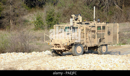 FORT HOOD, Texas — The Medium Mine Protected Vehicle, Type II (MMPV II) traverses a low-water crossing during execution of a route clearance mission as it is put through its paces during Operational Testing at Ft. Hood, Texas. The U.S. Army Operational Test Command gathers Information on the vehicle’s mobility as missions are conducted on multiple varying roadways and terrain. (Photo by Clay Beach, U.S. Army Operational Test Command Visual Information) Stock Photo