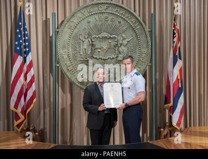 HONOLULU (May 5, 2017) - Governor of Hawaii David Ige, presents the Hawaii Military Appreciation Month proclamation to Maj. Gen. Kevin B. Schneider, chief of staff of U.S. Pacific Command. The proclamation identifies May 2017 as Hawaii Military Appreciation Month, to recognize Hawaii-based military members for their contributions to local communities. Stock Photo