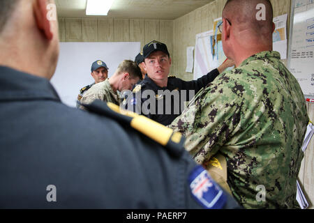 180717-N-LR347-014 NAVAL BASE POINT LOMA, Calif.  (July 17, 2018) - Royal New Zealand Navy (RNZN) Lt. Cmdr. Ben Martin, undersea mine countermeasures commander for Rim of the Pacific (RIMPAC) exercise in the Southern California area of operations, briefs RNZN Commodore Tony Millar, maritime component commander and representative of the Chief of Navy (New Zealand), left, and U.S. Navy Rear Adm. Dave Welch, commander, Mine Warfare Task Force, right, during a visit onboard Naval Base Point Loma, July 17. Twenty-five nations, 46 ships, five submarines, about 200 aircraft and 25,000 personnel are p Stock Photo