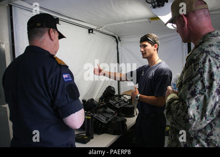 180717-N-LR347-015 NAVAL BASE POINT LOMA, Calif. (July 17, 2018) - Royal New Zealand Navy (RNZN) Leading Diver Kyran Bennett serving with the undersea mine countermeasures commander for Rim of the Pacific (RIMPAC) exercise in the Southern California area of operations briefs RNZN Commodore Tony Millar, maritime component commander and representative of the Chief of Navy (New Zealand), left, and U.S. Navy Rear Adm. Dave Welch, commander, Mine Warfare Task Force, right, during a visit to Naval Base Point Loma, July 17. Twenty-five nations, 46 ships, five submarines, about 200 aircraft and 25,000 Stock Photo