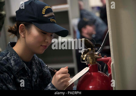 (Feb. 28, 2018) Aviation Structural Mechanic Airman Juhyun Lee, assigned to the aircraft carrier USS Gerald R. Ford (CVN 78), signs an inspection record card. Stock Photo