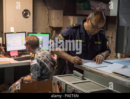 180716-N-XK809-1037 PEARL HARBOR, Hawaii (July 16, 2018) Chilean Navy Senior Chief Petty Officer Jose Mendez, attached to Combined Task Group 176, reviews documents following a battle update briefing in the Joint Operations Center of the amphibious assault ship USS Bonhomme Richard (LHD 6) during the Rim of the Pacific (RIMPAC) 2018 exercise. Twenty-five nations, 46 ships, five submarines, about 200 aircraft and 25,000 personnel are participating in RIMPAC from June 27 to Aug. 2 in and around the Hawaiian Islands and Southern California. The world’s largest international maritime exercise, RIM Stock Photo