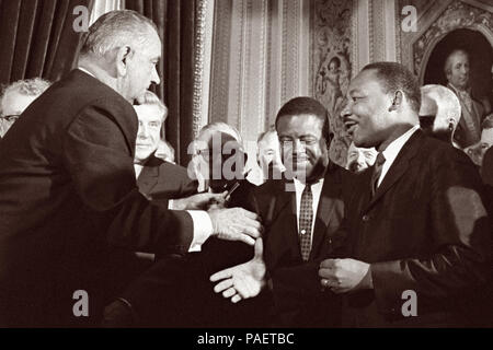 President Lyndon B. Johnson moves to shake hands with Dr. Martin Luther King after the signing of the Voting Rights Act on August 6, 1965 in the President's Room of the U.S. Capitol in Washington, D.C. Stock Photo