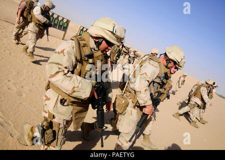 Seabees assigned to the 30th Naval Construction Regiment return to the firing line during weapons training in Kuwait before deploying Afghanistan. The regiment, homeported in Port Hueneme, Calif., is headed to Southern Afghanistan to relieve the 25th Naval Construction Regiment in support of Operation Enduring Freedom. Stock Photo