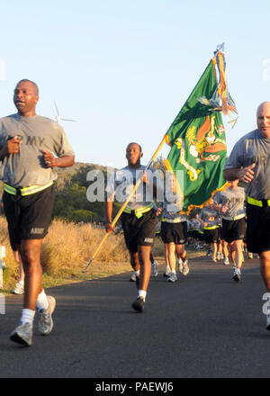 GUANTANAMO BAY, Cuba – Army Pfc. Shimron Duliepre, with the 525th Military Police (MP) Battalion, carries the battalion guidon as Army Lt. Col. Alex Conyers (left) leads the unit in a formation run around Joint Task Force (JTF) Guantanamo, April 9, 2010. The 525th MP Battalion provides a portion of the guard force inside the detention facilities at JTF Guantanamo. JTF Guantanamo conducts safe, humane, legal and transparent care and custody of detainees, including those convicted by military commission and those ordered released by a court. The JTF conducts intelligence collection, analysis and Stock Photo