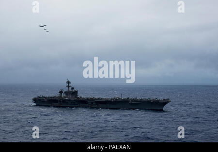 SEA (Feb. 14, 2017) A B-1B Lancer aircraft assigned Anderson Air Force Base, Guam, flies over the aircraft carrier USS Carl Vinson (CVN 70) as it transits the Philippine Sea. The B-1 is deployed in support of U.S. Pacific Command’s Continuous Bomber Presence (CBP) mission. In place since 2004, the CBP missions are conducted by U.S. Air Force bombers such as the B-1, B-52 Stratofortress and B-2 Spirit in order to provide non-stop stability and security in the Indo-Asia-Pacific region. The Carl Vinson Carrier Strike Group is on a western Pacific deployment as part of the U.S. Pacific Fleet-led i Stock Photo