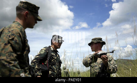 U.S. Marine Cpl. Lucas A. Dussaut, an assaultman with Lima Company, Battalion Landing Team, 3rd Battalion, 5th Marines, 31st Marine Expeditionary Unit, shows Philippine Army Maj. John Aling, with the Joint Command Training Center, and U.S. Marine Capt. David Murray, the ground liaison officer with the Joint US Military Assistance Group, an unmanned aerial surveillance system at Colonel Ernesto P. Ravina Air Base, Philippines on Oct. 2, 2017.  Elements of the 31st Marine Expeditionary Unit are currently in support of the 3rd Marine Expeditionary Brigade, participating in exercise KAMANDAG. Bila Stock Photo