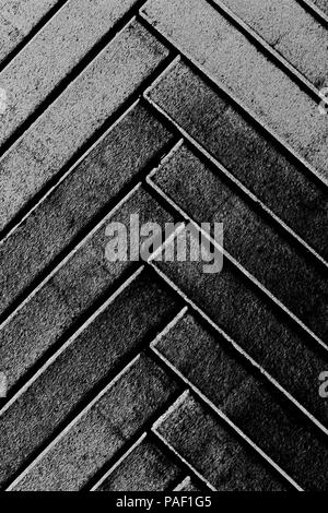 Grey narrow herringbone pattern stylised bricks background vertical composition Stock Photo