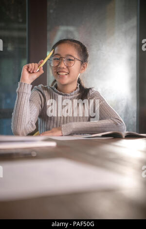 cheerful asian teenager wisdom thinking Stock Photo