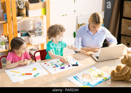 Children modeling clay in class Stock Photo
