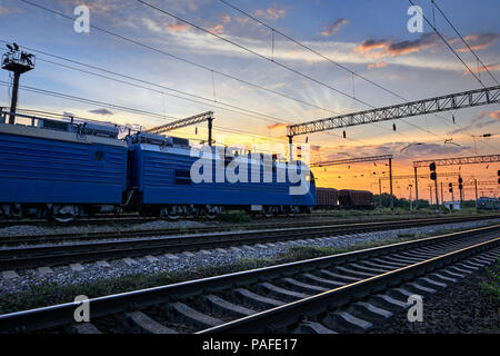 railroad infrastructure during beautiful sunset and colorful sky, trains and wagons, transportation and industrial concept Stock Photo