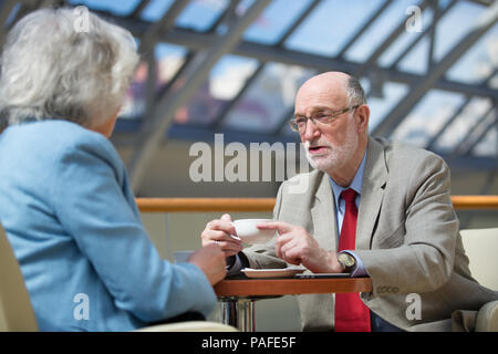 Senior people talking in cafe drinking coffee Stock Photo