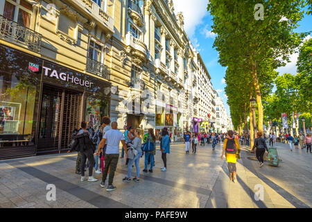 Paris, France - July 2, 2017: tourists walk on the most famous avenue in Paris, the Champs Elysees, known for luxury and shopping that starts from Place de La Concorde to Place Charles de Gaulle. Stock Photo