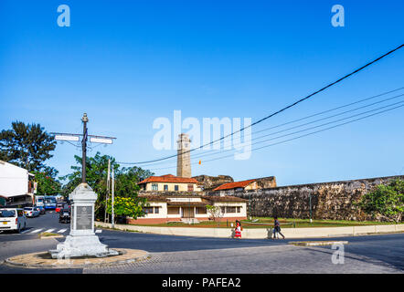 Clock Tower and old fashioned signpost and plaque commemorating Galle Heritage Trust near the Main Gate entrance to Galle Fort, Galle, Sri Lanka Stock Photo