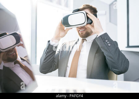 Businessman Using VR at Work Stock Photo