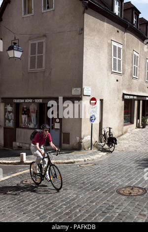 Male cyclist riding his bike on cobbled street