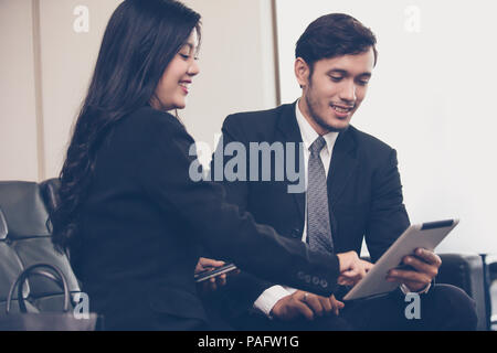 businessmen and group using notebook for business partners discussing documents and ideas at meeting and business women smiling happy for working Stock Photo