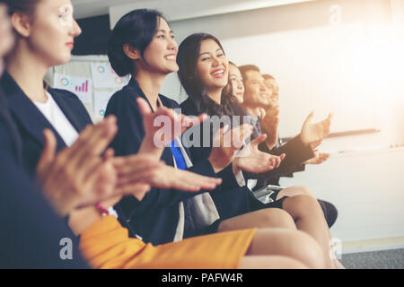 Business executives applauding in a business meeting Stock Photo