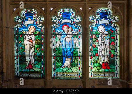 Stained glass depicting St Agnes, St Mary and St Dorothy. The Cloister Gloucester Cathedral UK. May 2018 Stock Photo