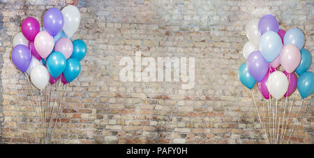 A lot of balloons at front of bricks wall. Stock Photo