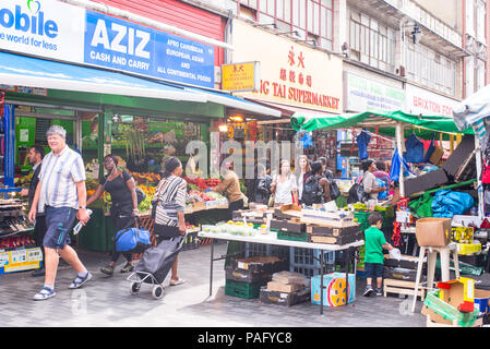 People shopping in Electric Avenue, Brixton, London. Built in the 1880s, it was the first market street to be lit by electricity. Today, the street co Stock Photo