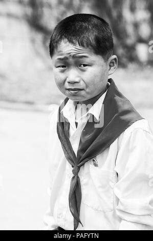 NORTH KOREA - MAY 1, 2012: Portrait of a Korean pioneer boy during the celebration of the International Worker's Day in N.Korea, May 1, 2012. May 1 is Stock Photo