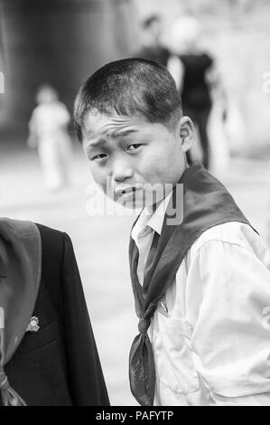 NORTH KOREA - MAY 1, 2012: Portrait of a Korean pioneer boy during the celebration of the International Worker's Day in N.Korea, May 1, 2012. May 1 is Stock Photo