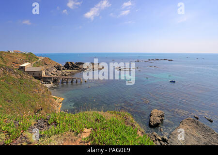 The old lifeboat station in Polpeor Cove on Lizard Point from the South West Coast Path, Cornwall, England, UK. Stock Photo