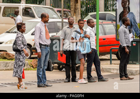 GABON - MARCH 6, 2013: Unidentified Gabonese people waiting for a bus on a bus stop in Gabon, Mar 6, 2013. People of Gabon suffer of poverty due to th Stock Photo