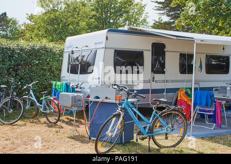 fendt caravan on a campsite in Benodet, Brittany with bikes and camping kitchen Stock Photo