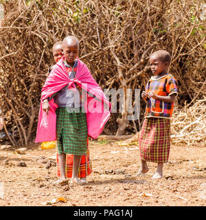 AMBOSELI, KENYA - OCTOBER 10, 2009: Unidentified Massai woman and children wearing tribal typical clothes in Kenya, Oct 10, 2009. Massai people are a  Stock Photo