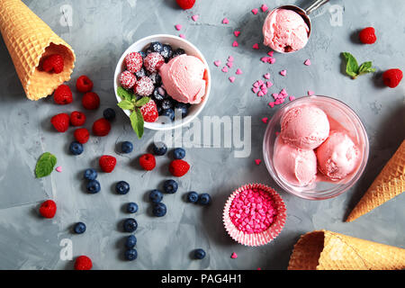 Strawberry ice cream with different berries and mint on a gray background. Stock Photo