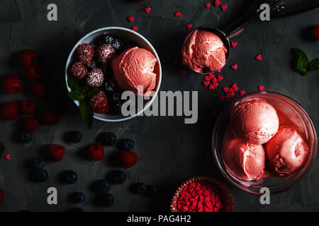 Strawberry ice cream with different berries and mint on a gray background. Stock Photo
