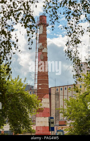 Vitebsk, Belarus - July 7, 2018: Old pipe factory chimney made of red brick,  located at large-scale bakery. Stock Photo