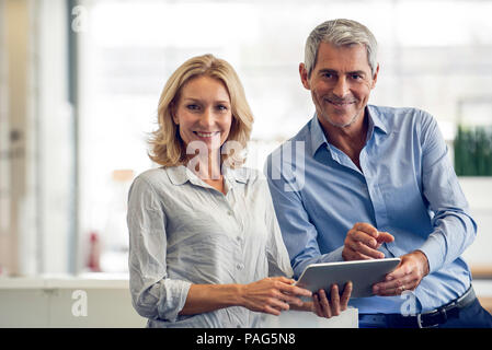 Businesspeople using digital tablet Stock Photo