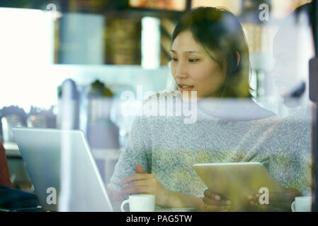 Young friends using laptop and digital tablet Stock Photo
