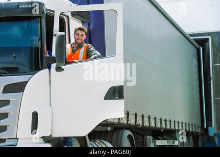 Worker standing by lorry door Stock Photo