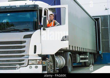 Worker standing by lorry door Stock Photo