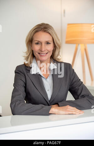 Close-up of receptionist smiling Stock Photo