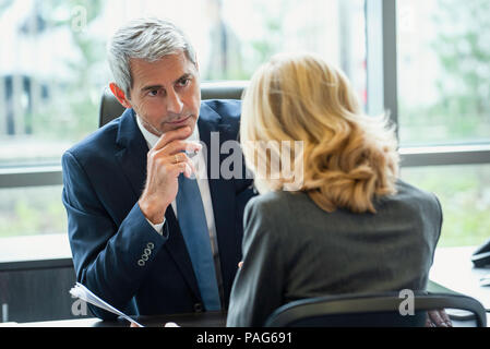 Businesspeople discussing in office Stock Photo